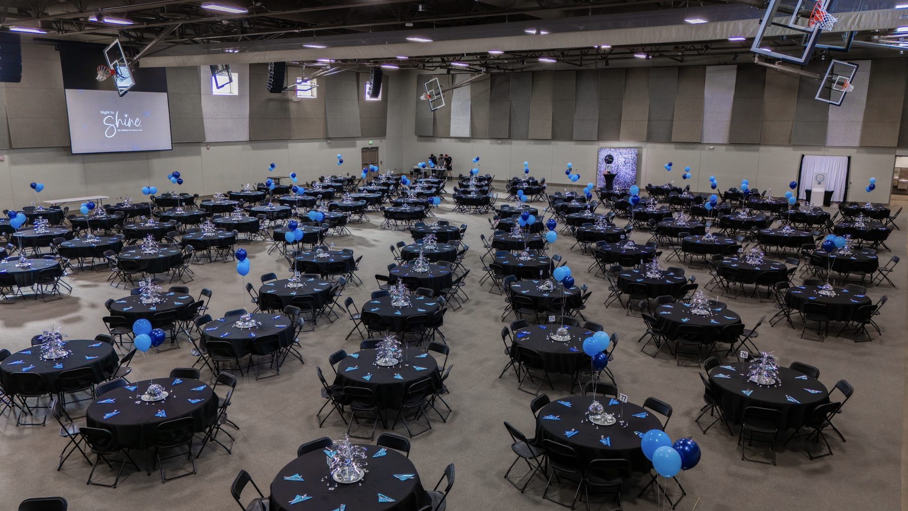 The event hall set with round tables for a banquet