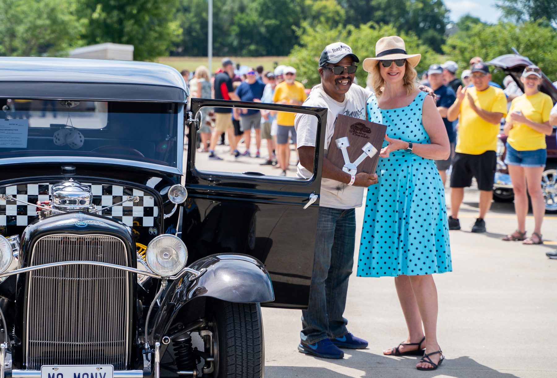 Visitors browsing rows of classic cars